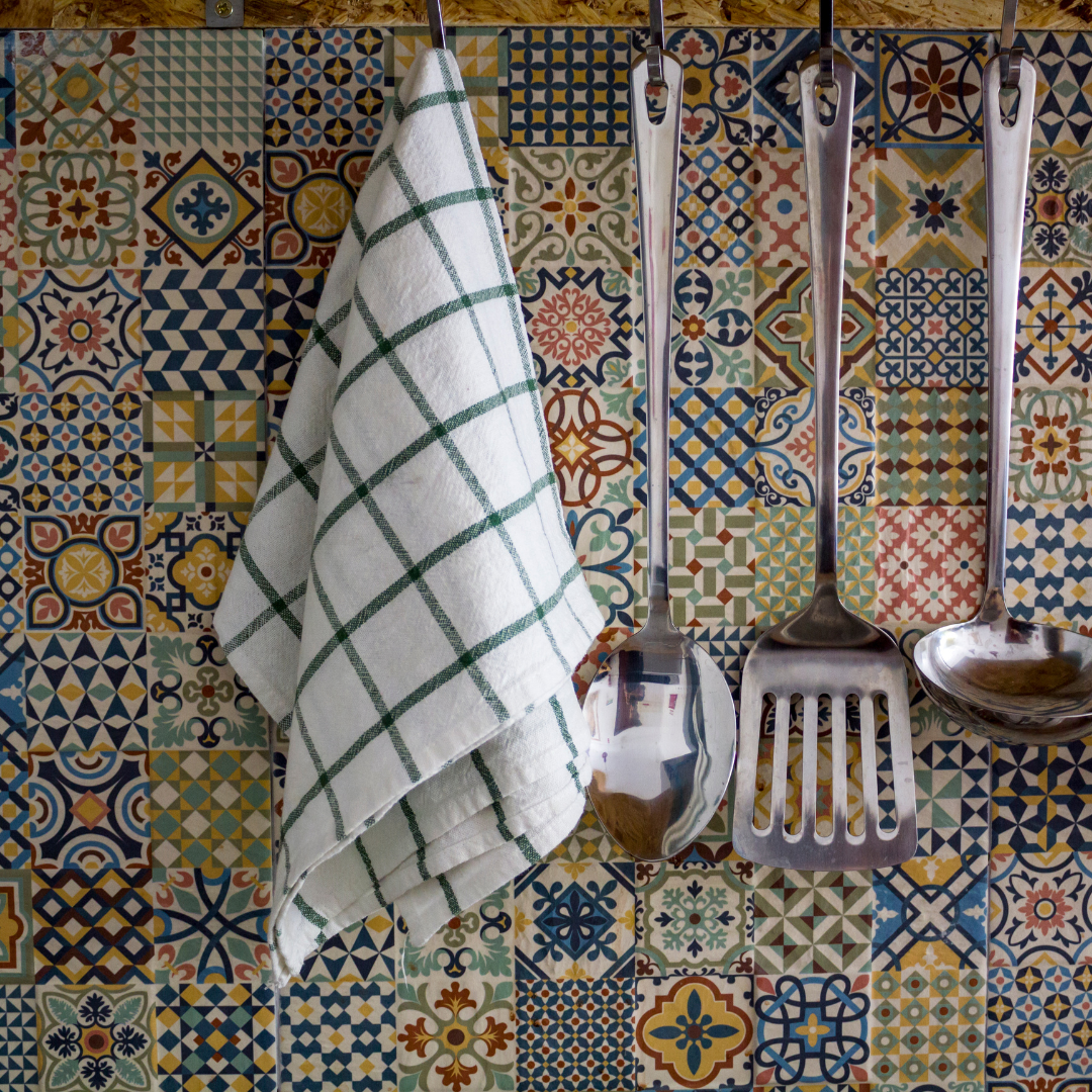 Decorative tile and kitchen utensils on display